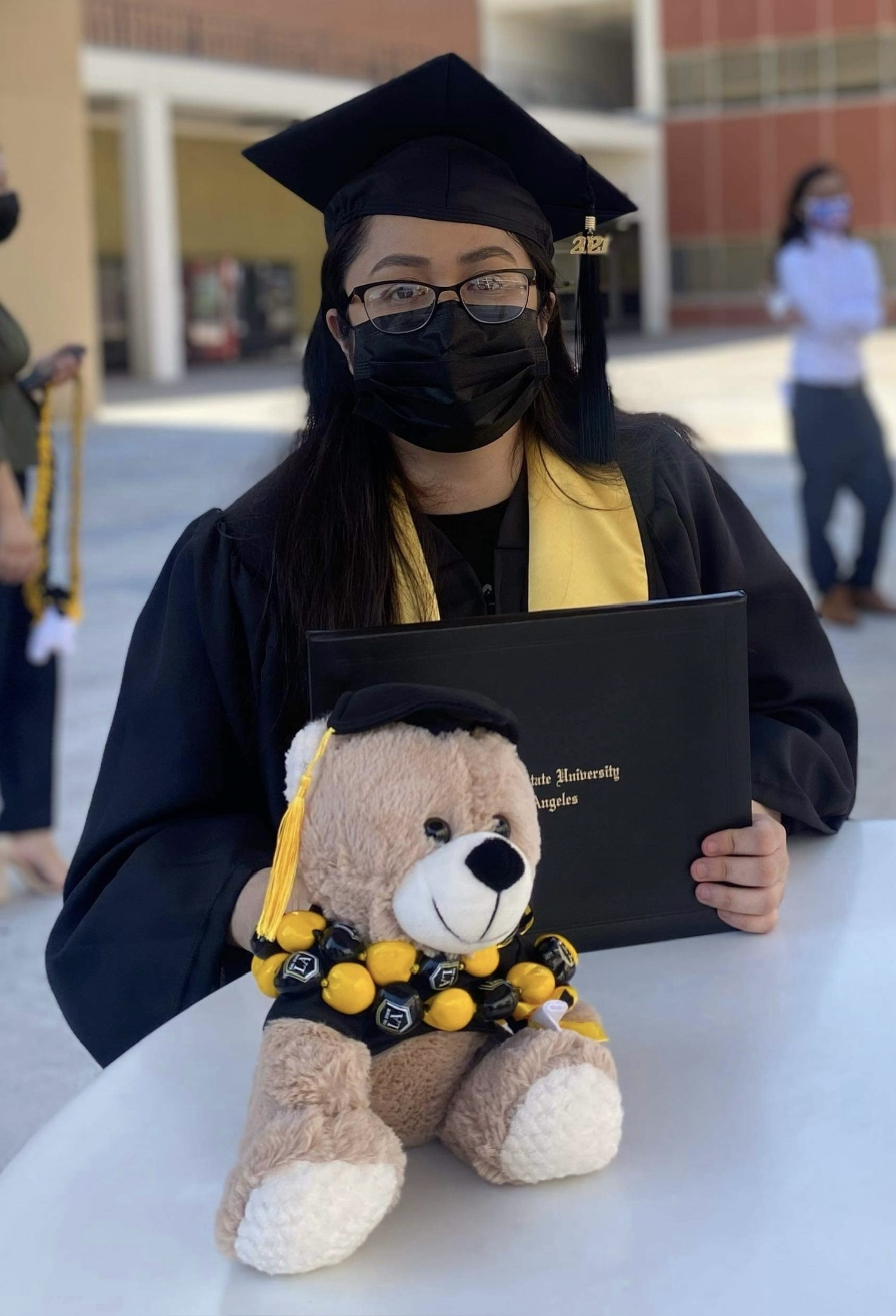 Myself sitting down and showcasing my disploma after graduating.